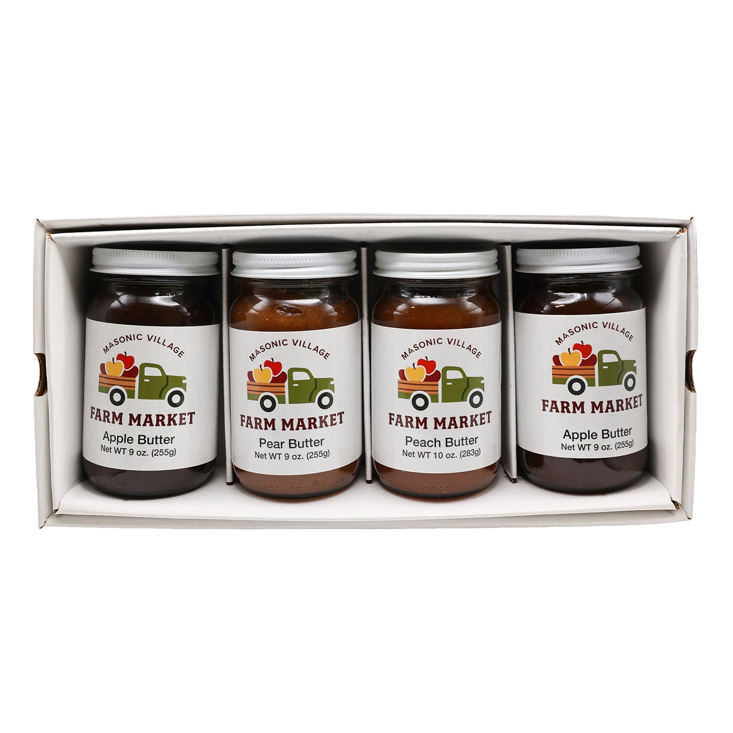 Four jars of Masonic Village Farm Market butter in a box on a white background.