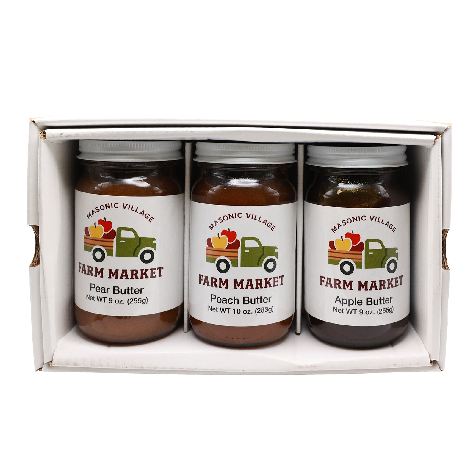 Three jars of farm market butter in a box with 'Masonic Village' branding.