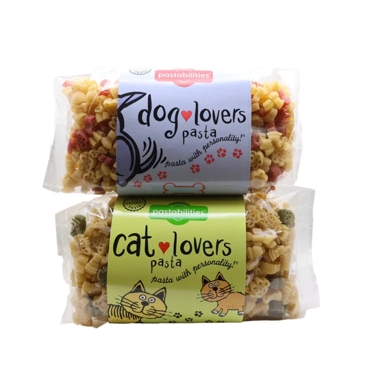 Two packages of pet food labeled 'dog lovers pasta' and 'cat lovers pasta' on a white background.