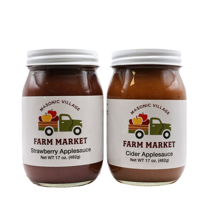 Two jars of Masonic Village Farm Market applesauce on a white background