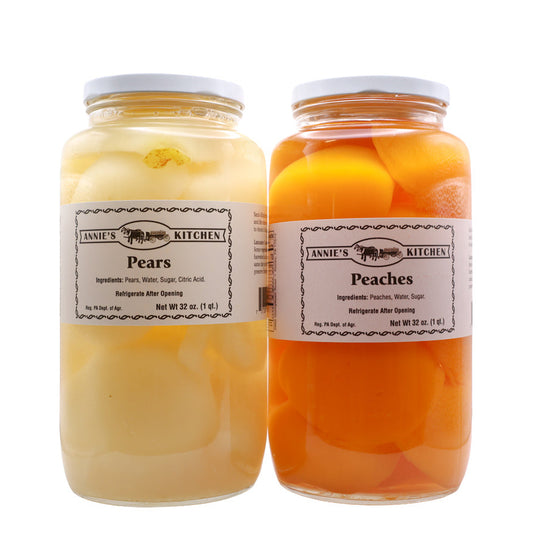 Two jars of canned pears and peaches from Annie's Kitchen on a white background